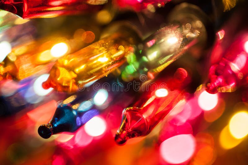 Christmas tree lights bulbs closeup on bokeh colorful stock photography