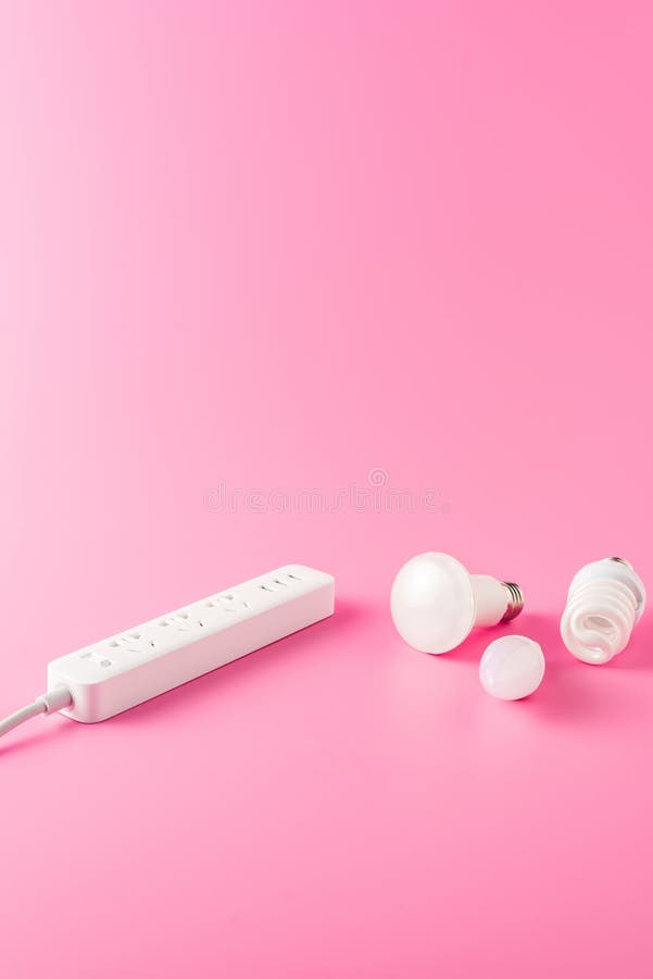 Close-up view of socket outlet and various light bulbs. On pink royalty free stock photo