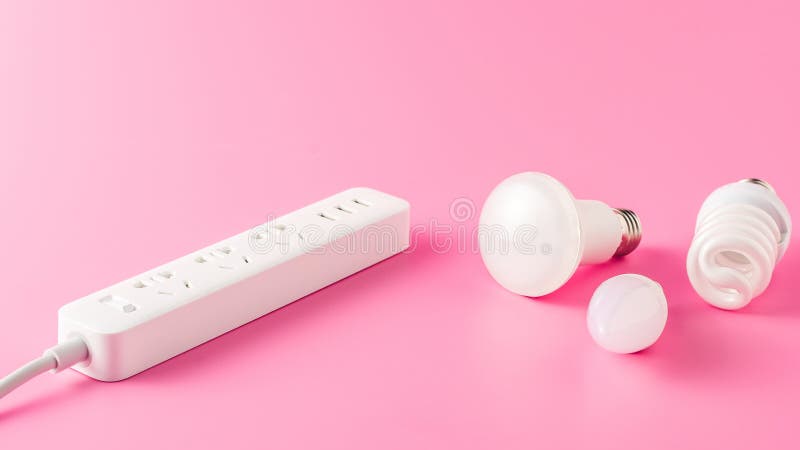 Close-up view of various light bulbs and socket outlet. On pink royalty free stock image