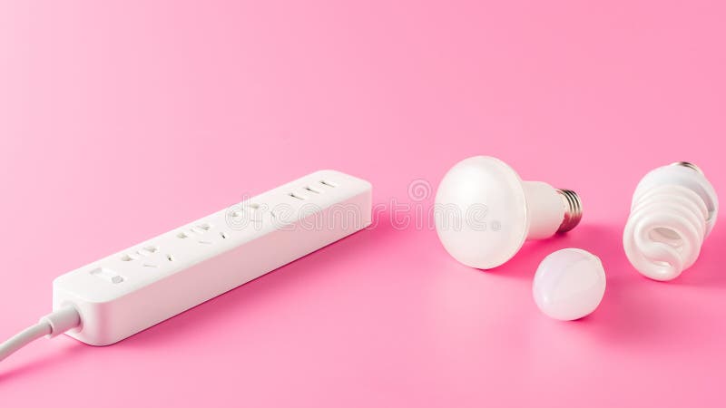 Close-up view of various light bulbs and socket outlet. On pink royalty free stock image Close-up view of various light bulbs and socket outlet. On pink royalty free stock image
