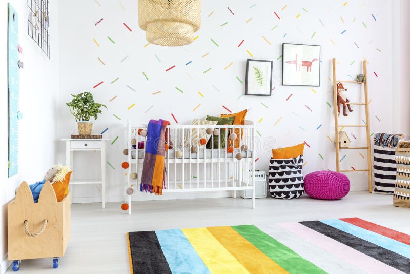 Colorful carpet in baby room. Colorful carpet on a white floor in cozy modern baby room royalty free stock image