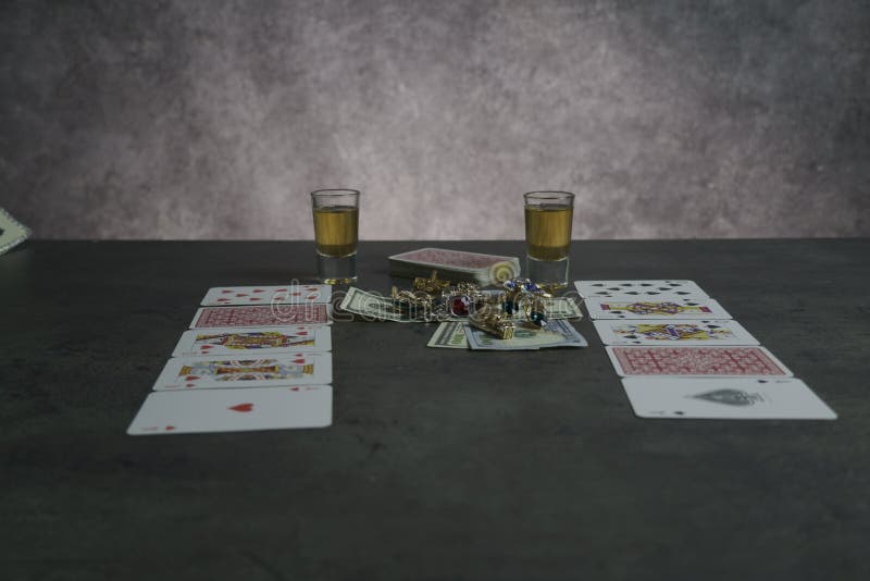 The combination of Flash Royal cards on a gray table with money and gold. Close-up. Poker game. Photo royalty free stock photography