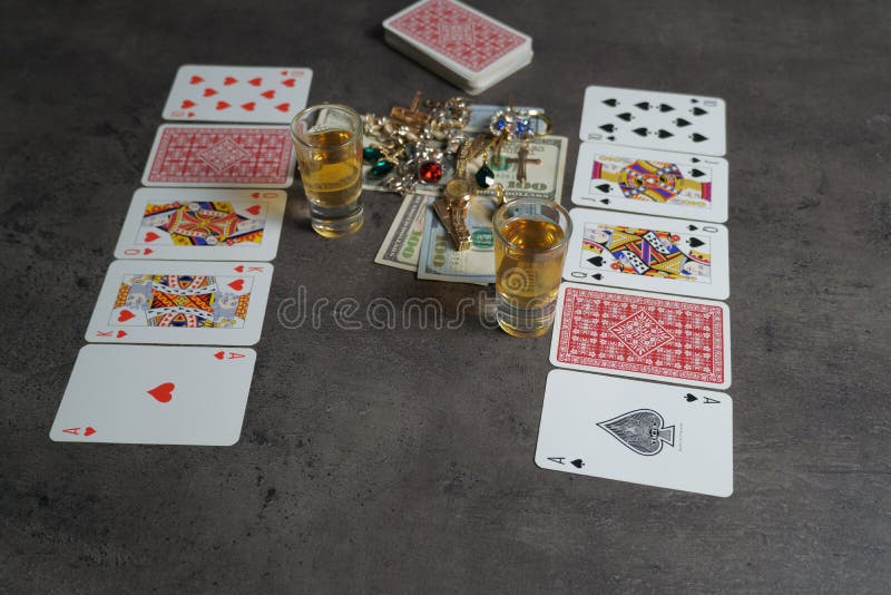 The combination of Flash Royal cards on a gray table with money and gold. Close-up. Poker game. Photo royalty free stock images