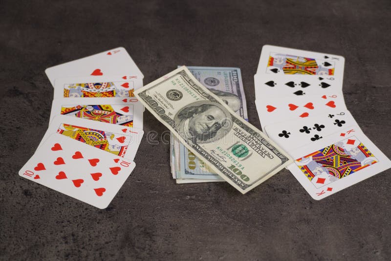 The combination of Flash Royal cards on a gray table with money and gold. Close-up. Poker game. Photo stock photos