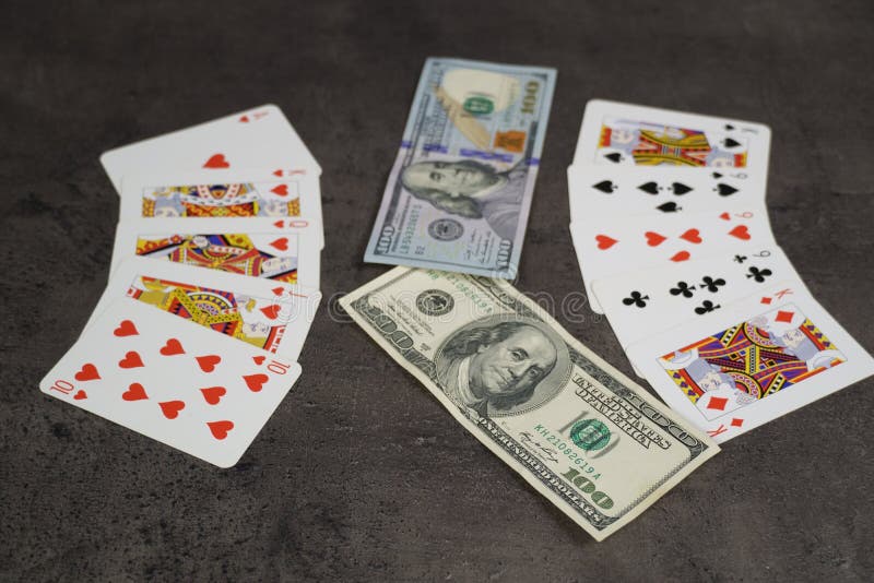 The combination of Flash Royal cards on a gray table with money and gold. Close-up. Poker game. Photo royalty free stock photography