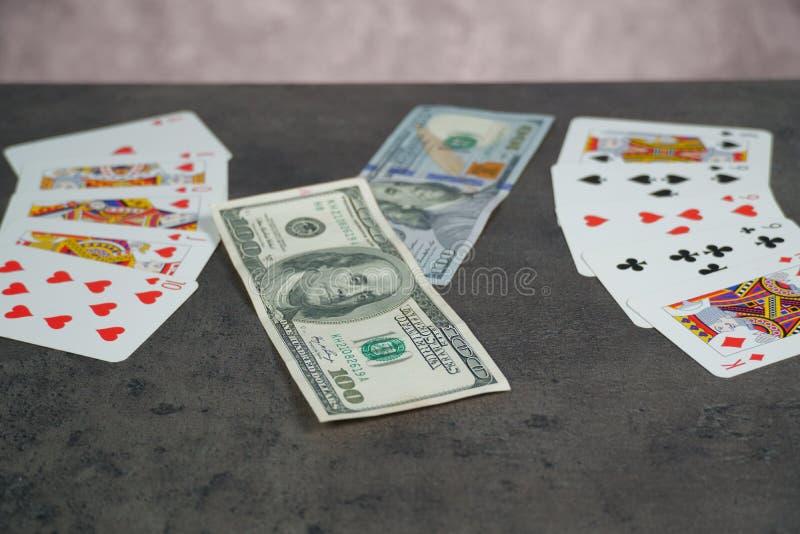 The combination of Flash Royal cards on a gray table with money and gold. Close-up. Poker game. Photo stock images
