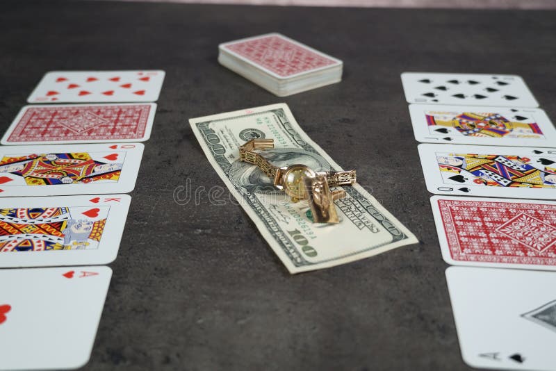 The combination of Flash Royal cards on a gray table with money and gold. Close-up. Poker game. Photo royalty free stock photo