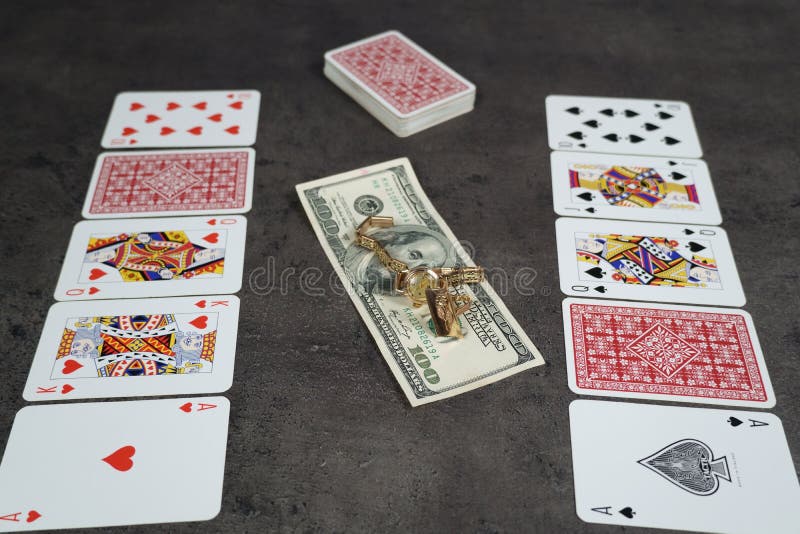 The combination of Flash Royal cards on a gray table with money and gold. Close-up. Poker game. Photo royalty free stock photos