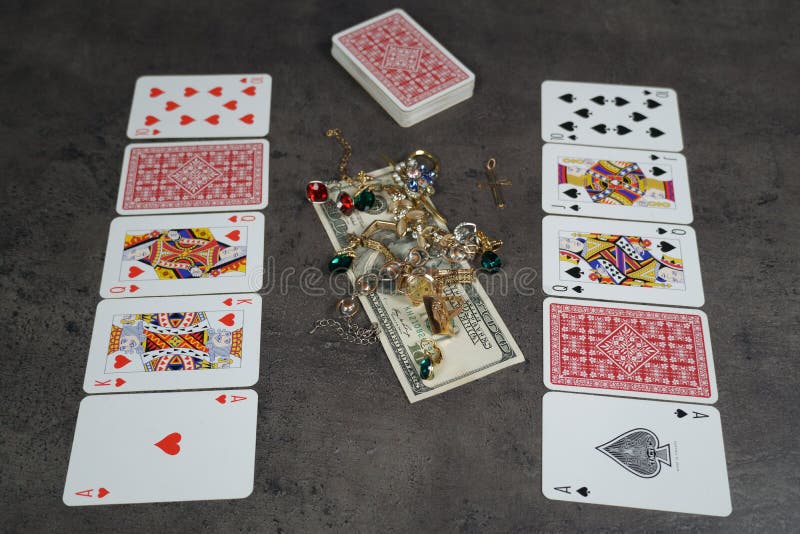 The combination of Flash Royal cards on a gray table with money and gold. Close-up. Poker game. Photo stock images