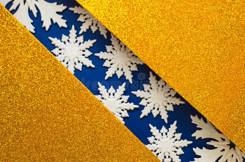 Combination of gold and blue with white lace snowflakes, shiny holiday background. Christmas card, background for congratulations. A combination of gold and blue stock images
