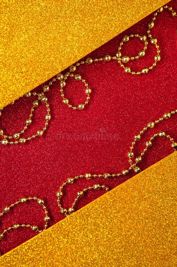 Combination of red and gold with beautiful beads, shiny holiday background. Christmas card, background for congratulations. A combination of red and gold with stock photo