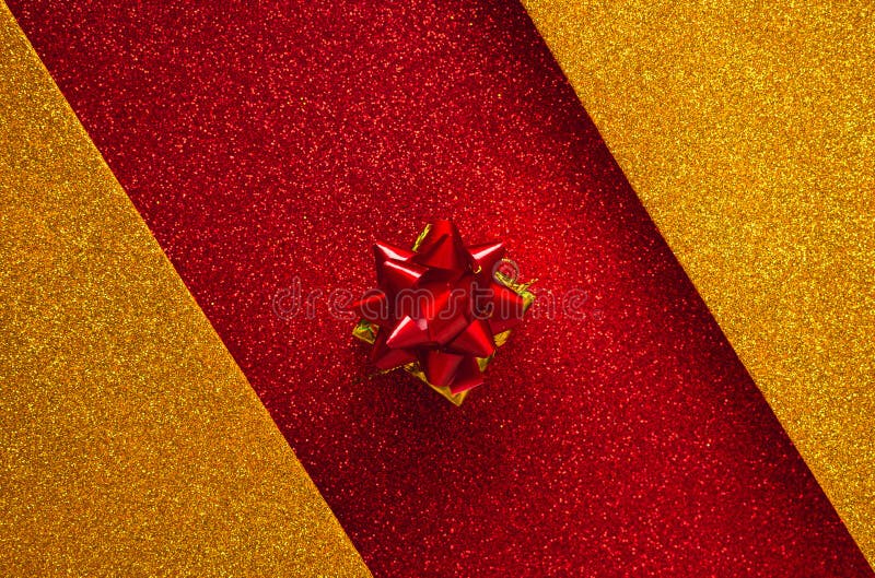 Combination of red and gold with a gift box, shiny holiday background. Christmas card, background for congratulations. A combination of red and gold with a gift stock photography