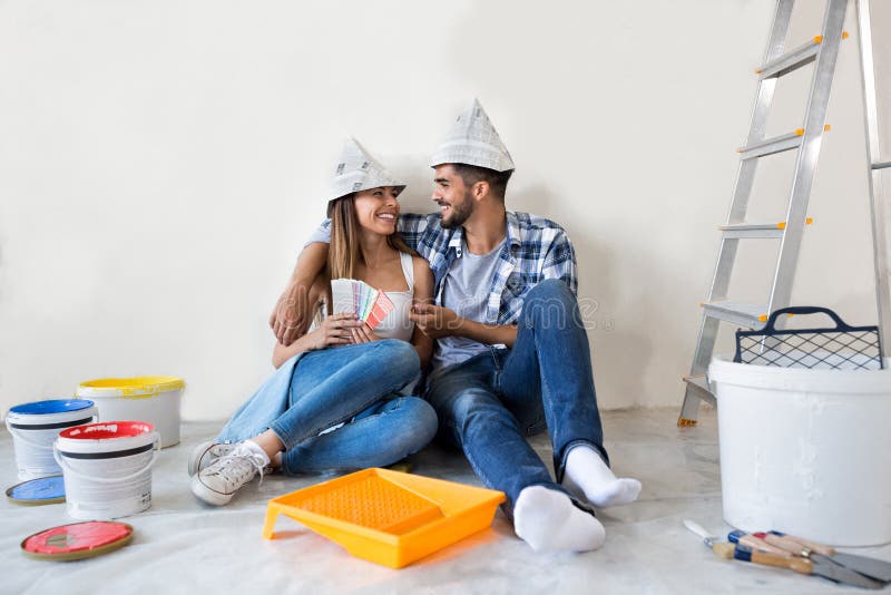 Couple doing home renovations. Choosing colors and enjoy in new apartment royalty free stock photos