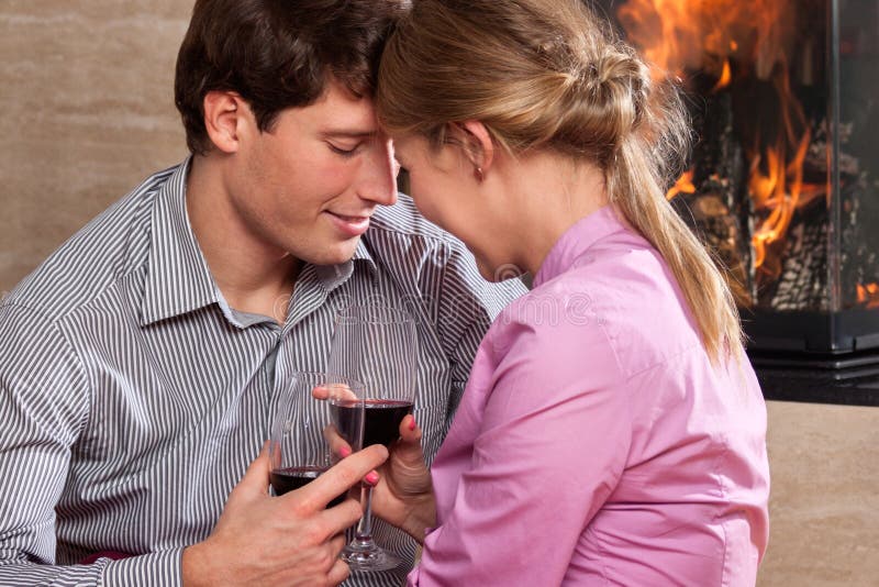 Couple drinking by fire royalty free stock image