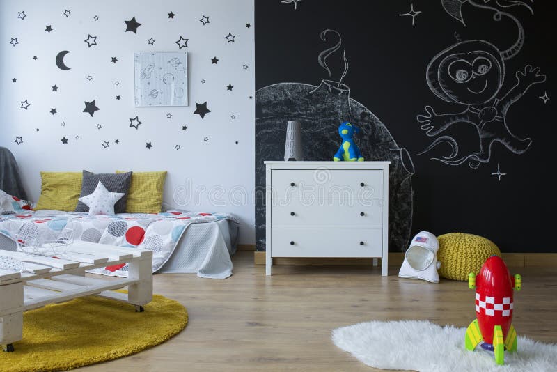 Cozy space-themed room. Cozy space-themed children`s room with blackboard wall stock image