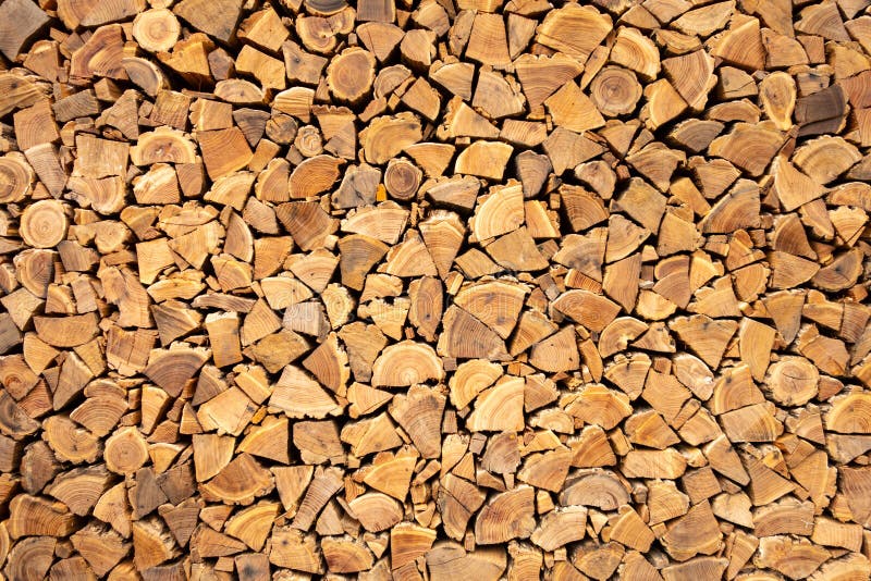 Creative brown background of neatly stacked firewood. Brown texture of natural wood. Creative brown background of neatly stacked firewood. Brown texture of royalty free stock photo