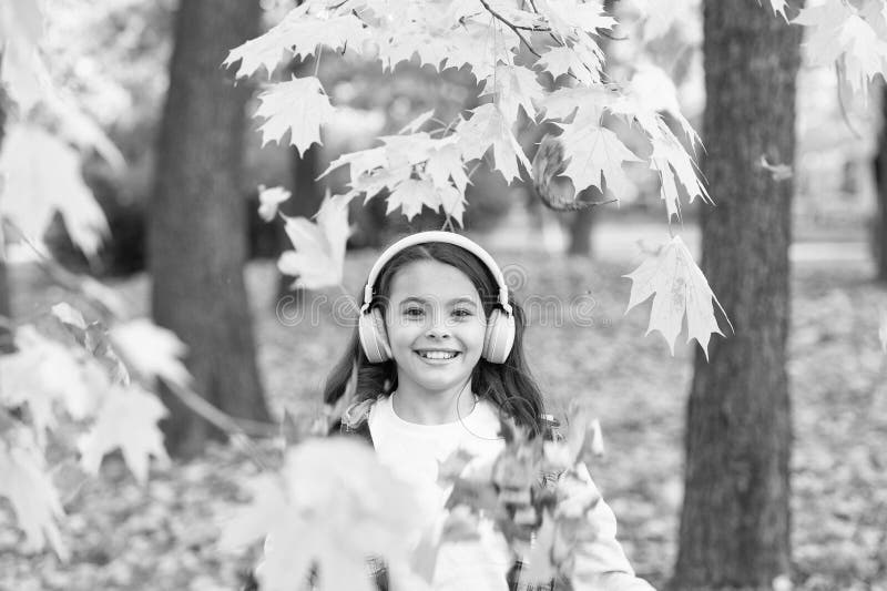 Crispy autumn air. Happy small child smile listening to music on autumn day. Little girl play on fresh air on autumn. Landscape. Smell the crisp air and feel royalty free stock photos