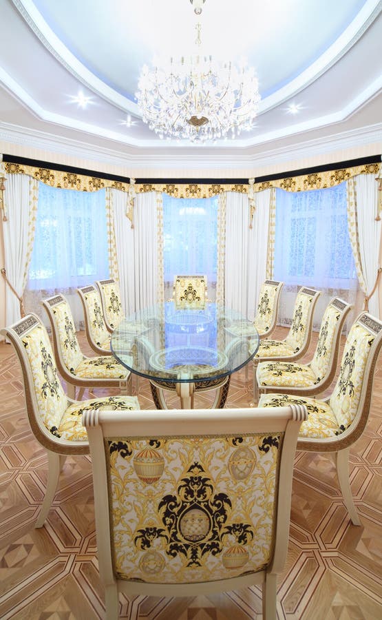 Dining room with luxury gilt furniture and beautiful table stock image