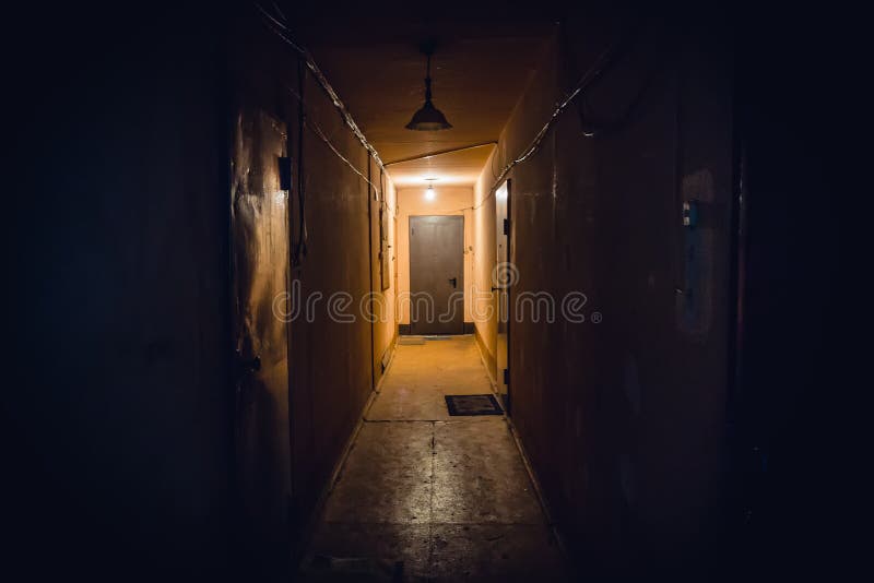 Dirty empty dark corridor in apartment building, doors, lighting lamps stock images