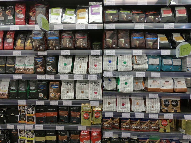 Dubai UAE - May 2019: Several packs of coffee beans and Turkish coffee on a wall of shelves. Lanes of shelves with goods products stock photo