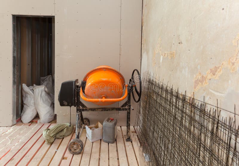 Electric concrete mixer in an apartment during on the renovation and construction. Remodel royalty free stock photo