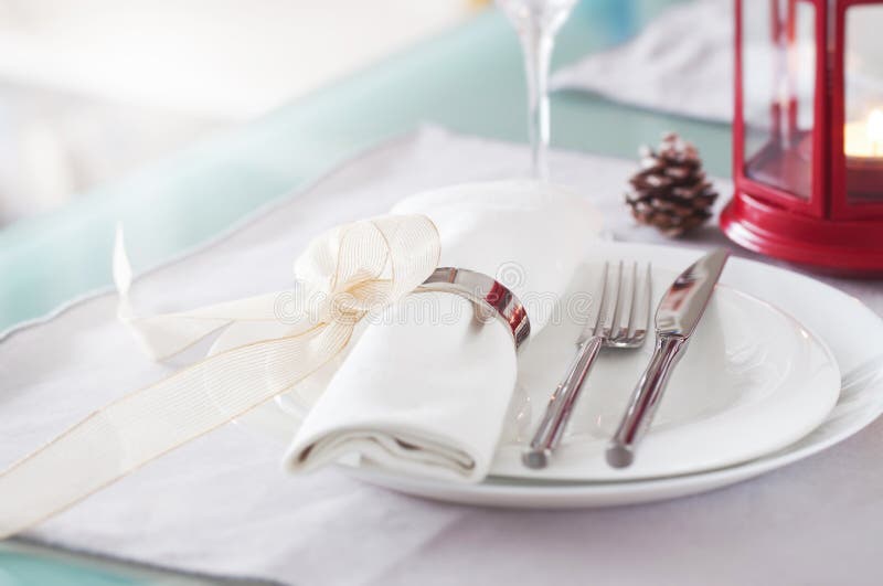 Elegant decorated Christmas table setting with modern cutlery, napkin, bow and christmas decorations stock image