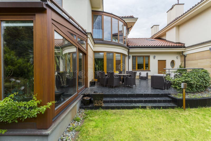 Elegant villa terrace with garden furniture stock photos