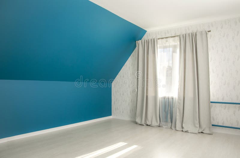 Empty bold blue tilted bed room wall, gray curtains, white sun day curtains. royalty free stock photos