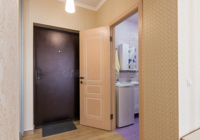 Entrance hall, front door and open door to the bathroom. Entrance hall, interior, front door and open door to the bathroom royalty free stock photos