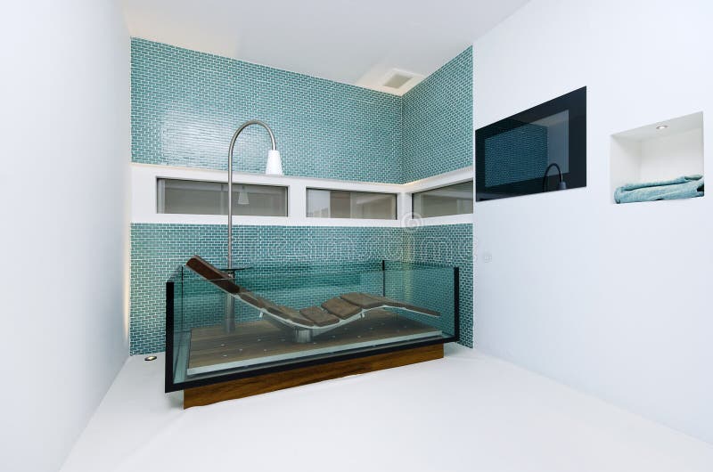 Extraordinary designer bathroom with glass bathtub royalty free stock photography