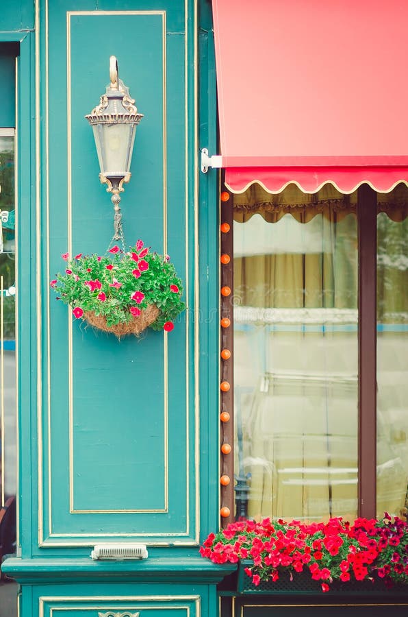 The facade of the cafe, decorated with fresh flowers. Fragment of the building. royalty free stock photography