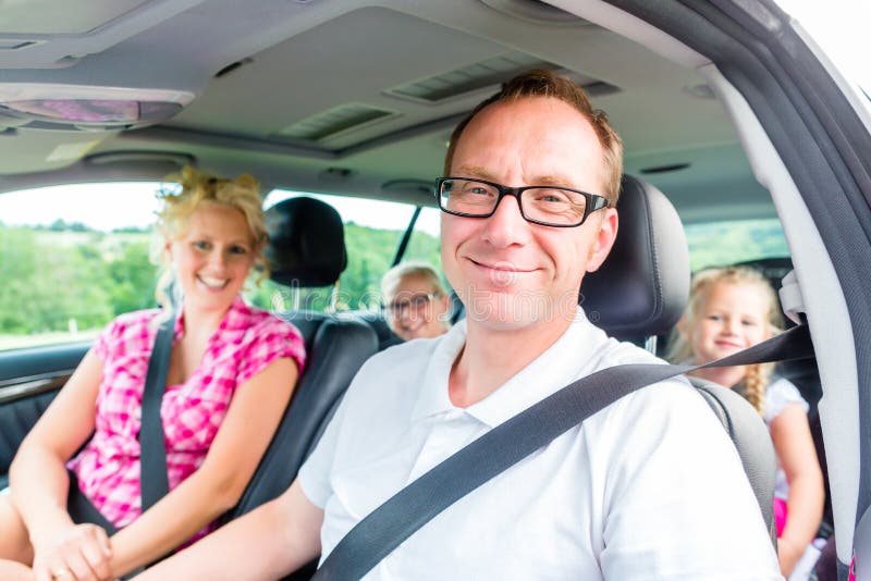 Family driving in car with seat belt stock image