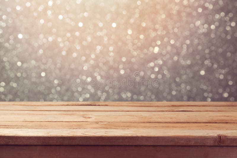 Festive background with empty wooden table over glitter bokeh lights royalty free stock images