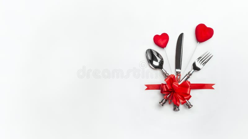Festive table place setting with red bow , cutlery and two hearts on white background, banner. Layout for Valentines day dinner in royalty free stock image