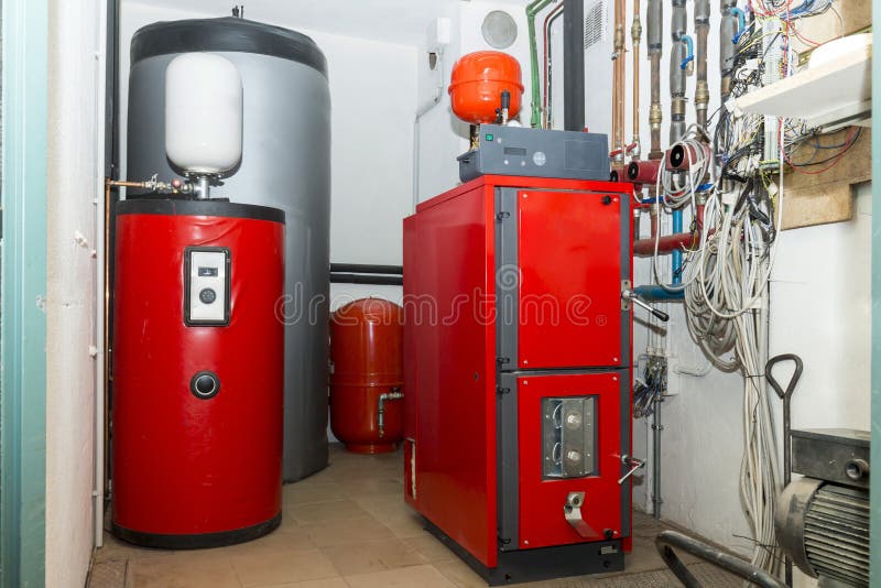 Firewood boiler and puffer thank. In the boiler room stock photography