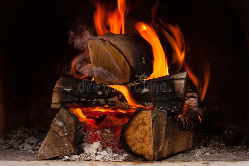 Firewood. Burning at the fireplace close up stock photos