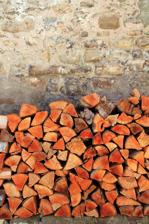 Firewood wood pile stacked triangle shape. Red color stock images