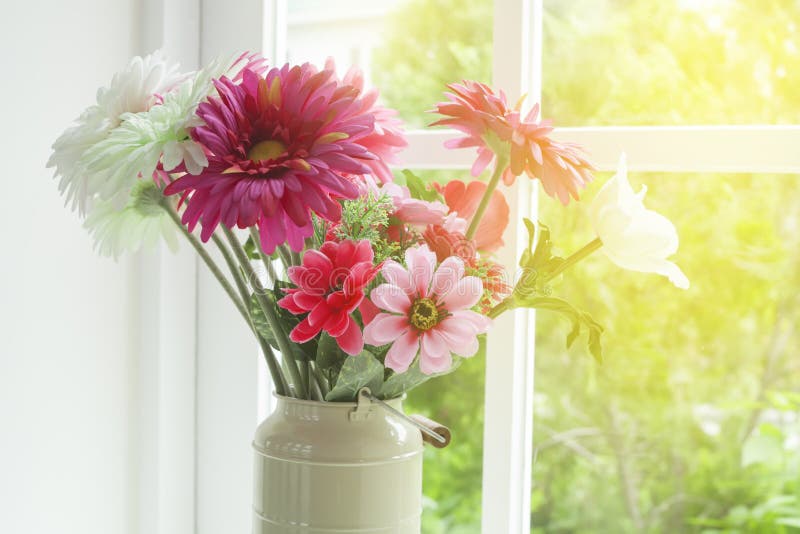 Flowers in glass vase. Near the window royalty free stock photos