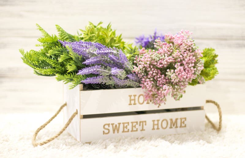 Flowers in a white wooden box. Interior decoration, interior composition. Flowers and branches in a wooden box royalty free stock photos