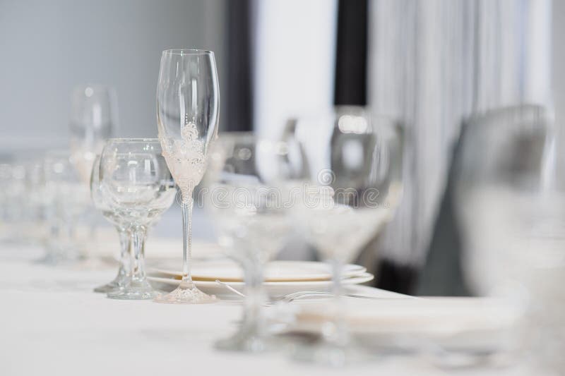 Glasses on the festive table setting. Wedding table decor concept. Table setting in classic style, setout. fine art stock photo