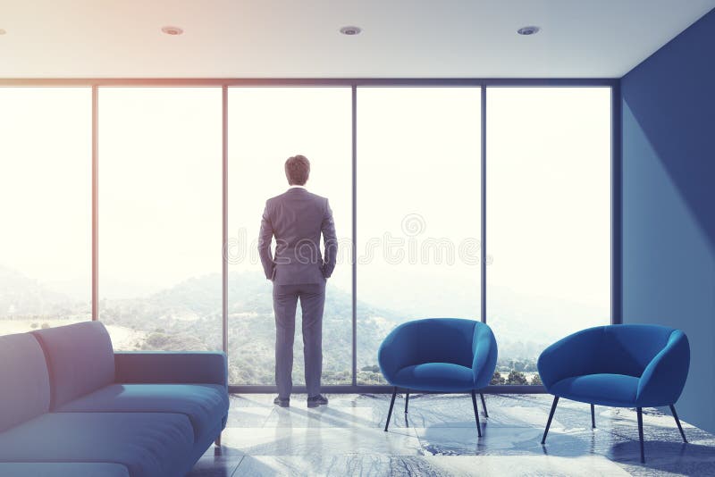 Gray living room, blue sofa, loft, businessman stock image