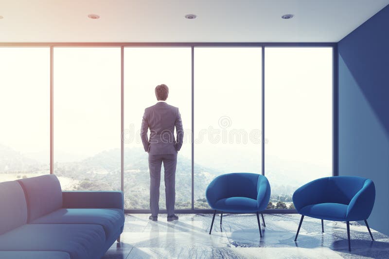 Gray living room, blue sofa, loft, businessman stock image Gray living room, blue sofa, loft, businessman stock image