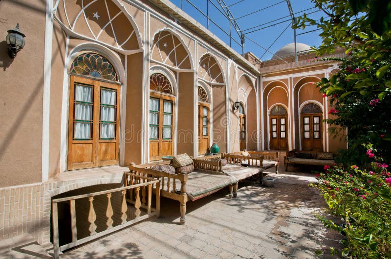 Green courtyard of beautiful iranian mansion with Ottoman beds. YAZD, IRAN: Green courtyard of beautiful iranian mansion with Ottoman beds for relaxation. With royalty free stock images Green courtyard of beautiful iranian mansion with Ottoman beds. YAZD, IRAN: Green courtyard of beautiful iranian mansion with Ottoman beds for relaxation. With royalty free stock images