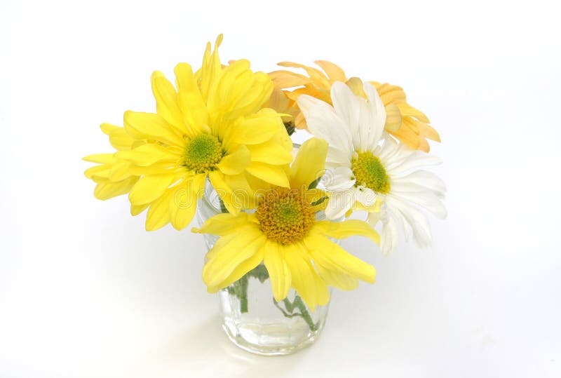 Group of flowers in a glass vase. Yellow, white and orange daisies. Useful as element design stock images
