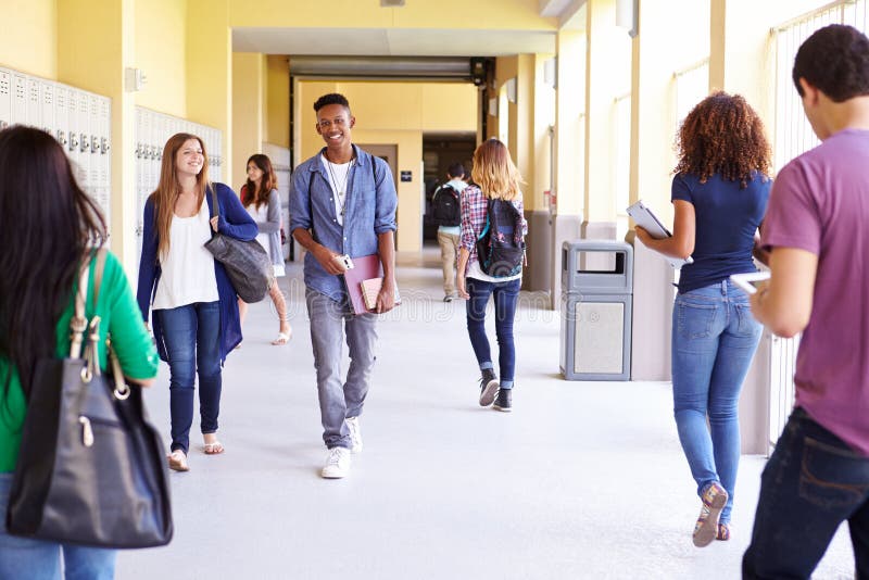 Group Of High School Students Walking Along Hallway stock images