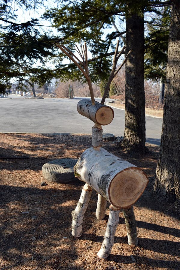 A handwork wooden unusual figure made of birch, looks like a deer. stock photo