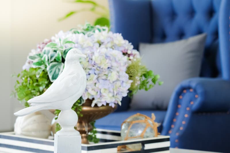 Home interior decoration with american Newport style, living room have a blue sofa and gray pillow with white bird and flowers stock image Home interior decoration with american Newport style, living room have a blue sofa and gray pillow with white bird and flowers stock image