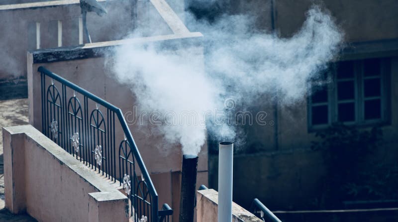 House kitchen smoke polluting air unique photograph. White smokes coming out from the house kitchen is polluting the air all over the place unique photograph royalty free stock images