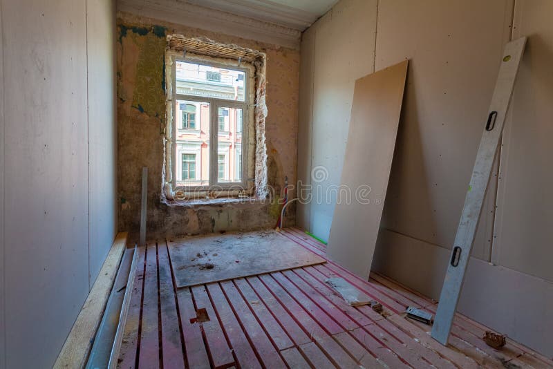 Interior of apartment with materials during on the remodeling, renovation, extension, restoration, reconstruction and construction. Upgrading wall from gypsum stock photography