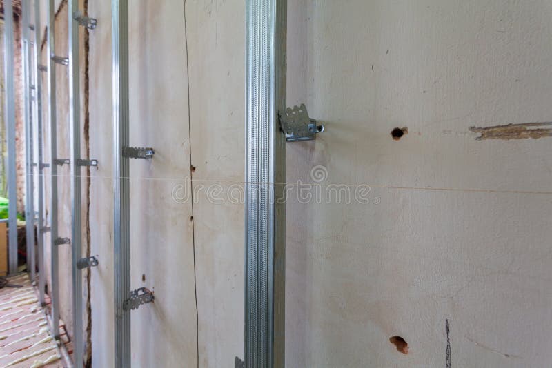 Interior of apartment with materials during on the renovation and construction. Making wall from drywall royalty free stock image